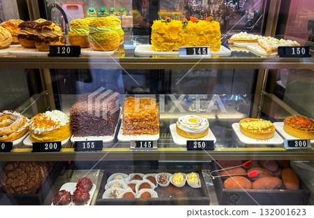 Delightful showcase of assorted cakes, pastries and bakery in bakery shop, showcasing variety of gourmet desserts and sweet treats 132001623