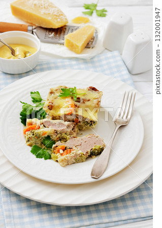 Cheesy ground meat vegetables casserole on a plate 132001947