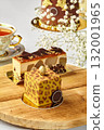 Delicious modern cakes with gold and chocolate decorations resting on wooden table 132001965