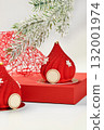 Red christmas mousse cakes decorated with snowflakes resembling santa claus hats 132001974