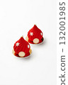 Two red christmas mousse cakes decorated with snowflakes and gold on white background 132001985