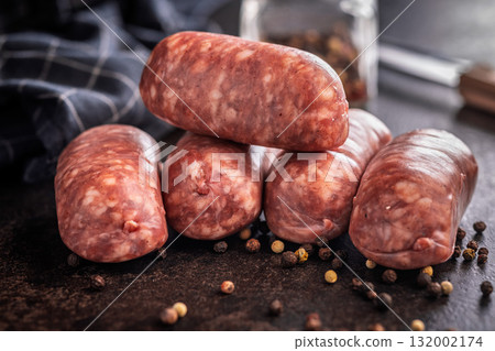 Photo of italian sausage salsiccia on black table. 132002174