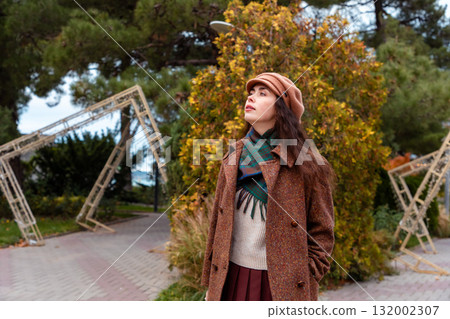 Peaceful fall streets welcome a solitary walk by a thoughtful woman enjoying a weekend escape. 132002307