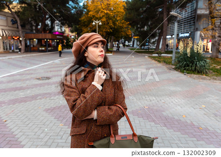 City walk on a fall weekend reveals a graceful woman deep in her emotions and thoughts. 132002309