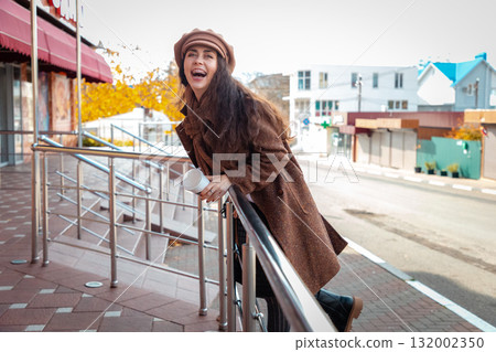 Mid shot of happy carefree young Caucasian woman is walking around the city. Concept of freedom and happiness Mid shot of happy carefree young Caucasian woman is walking around the city. Concept of freedom and happiness 132002350