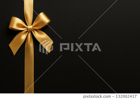 Elegant Golden Ribbon Bow on a Dark Background for Special Occasions and Celebrations 132002417