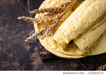 Lavash flat bread on green background Lavash flat bread on green background 132002535