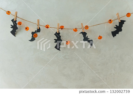 Halloween Garland with Pumpkin Lights and Bat Cutouts on Textured Wall Halloween Garland with Pumpkin Lights and Bat Cutouts on Textured Wall 132002739