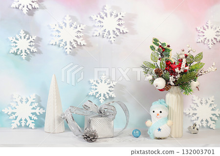 Christmas Eve concept. Christmas and New Year's mockup for product design and display featuring snowflakes and a snowman, a creative Christmas bouquet of live fir branches and decorations 132003701