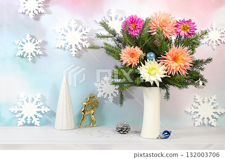 Christmas Eve concept. Christmas and New Year's mockup for design and product display, a creative Christmas bouquet of fresh fir branches in a vase with chrysanthemum flowers and decorations Christmas Eve concept. Christmas and New Year's mockup for design and product display, a creative Christmas bouquet of fresh fir branches in a vase with chrysanthemum flowers and decorations 132003706