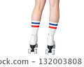 Female teen wearing retro roller skates with striped socks 132003808