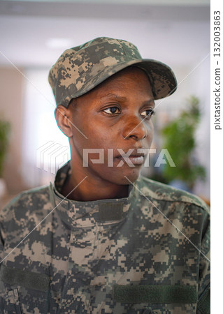 Confident african american female soldier looking away wearing camouflage uniform Confident african american female soldier looking away wearing camouflage uniform 132003863