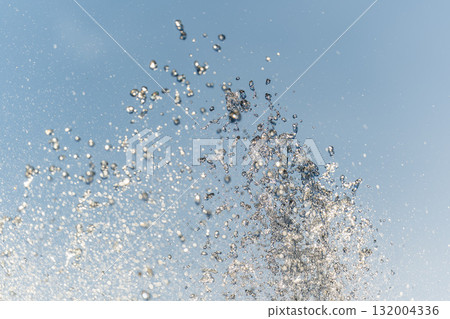 Splashes and jets of water against light background. Splashes and jets of water against light background. 132004336