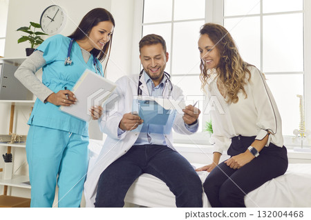 Doctor and nurse looking to medical test results and prescribe treatment to patient in clinic. Doctor and nurse looking to medical test results and prescribe treatment to patient in clinic. 132004468