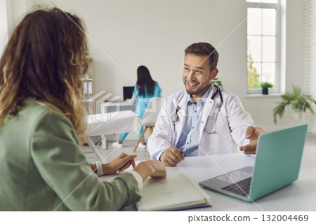 Woman visiting a doctor at the medical office during medical examination. Woman visiting a doctor at the medical office during medical examination. 132004469