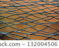 Woven metal mesh forming a grid fence structure.AI Generated 132004506