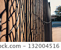 Woven metal mesh forming a grid fence structure.AI Generated 132004516