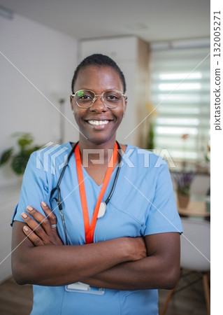 Confident African American female doctor smiling with arms crossed 132005271