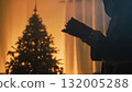 Silhouette Of A Mysterious Man Reads Book In Front Of Christmas Tree In The Room 132005288
