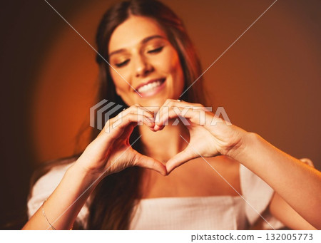 Woman, hand heart sign and love symbol of a happy female person in studio. Smile, happiness and loving emoji hands gesture with brown background and gen z model ready for a valentines day date Woman, hand heart sign and love symbol of a happy female person in studio. Smile, happiness and loving emoji hands gesture with brown background and gen z model ready for a valentines day date 132005773