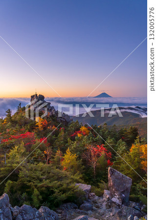 The Sword of the Sky shining in the morning sun on Tengu Rock with autumn leaves from Tengu Peak in the Okuchichibu Mountains in autumn and Mount Fuji in the morning glow The Sword of the Sky shining in the morning sun on Tengu Rock with autumn leaves from Tengu Peak in the Okuchichibu Mountains in autumn and Mount Fuji in the morning glow 132005776
