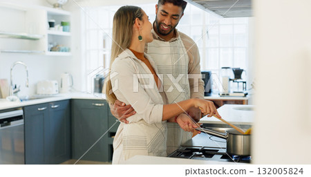 Couple, cooking and pot in home kitchen, hug and smile with romance, love and care with conversation. Man, woman and happy to prepare food together, embrace and helping hand for diet with nutrition Couple, cooking and pot in home kitchen, hug and smile with romance, love and care with conversation. Man, woman and happy to prepare food together, embrace and helping hand for diet with nutrition 132005824
