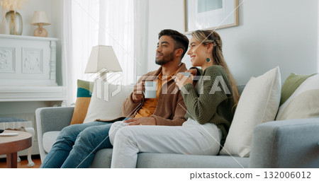 Relax, coffee and a couple watching tv in their home together for streaming in the morning. Love, smile or happy with a man and woman on a living room sofa for bonding or subscription entertainment Relax, coffee and a couple watching tv in their home together for streaming in the morning. Love, smile or happy with a man and woman on a living room sofa for bonding or subscription entertainment 132006012