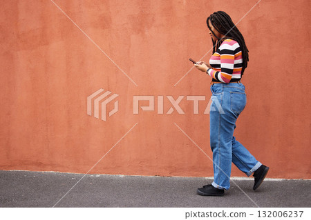 Black woman walking with smartphone in city, outdoor with technology, chat and communication with travel and fashion. Social media, urban street and wall with mockup and 5g, female in Jamaica Black woman walking with smartphone in city, outdoor with technology, chat and communication with travel and fashion. Social media, urban street and wall with mockup and 5g, female in Jamaica 132006237