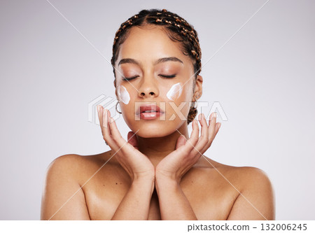 Black woman, cleaning cream and portrait of a young model with facial mask, moisturizer and wellness. Studio, beauty and female with dermatology, lotion and cosmetic face cream for glow and self care Black woman, cleaning cream and portrait of a young model with facial mask, moisturizer and wellness. Studio, beauty and female with dermatology, lotion and cosmetic face cream for glow and self care 132006245