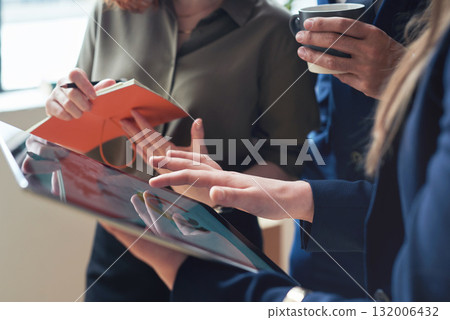 Teamwork, marketing agency or business people hands on tablet in meeting for company growth, strategy review or innovation. Group of startup employee for SEO analytics or planning KPI sales report Teamwork, marketing agency or business people hands on tablet in meeting for company growth, strategy review or innovation. Group of startup employee for SEO analytics or planning KPI sales report 132006432