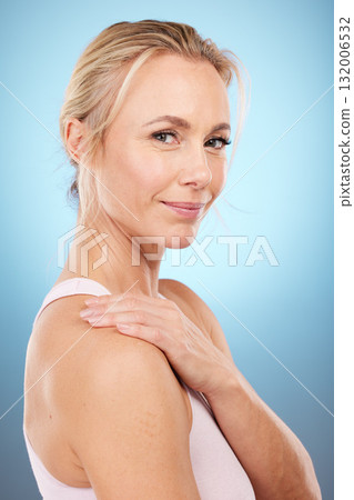 Beauty, woman and portrait in studio for skincare, dermatology and wellness cosmetics on blue background. Happy mature female model, facial and smile for aesthetic glow, laser transformation and face Beauty, woman and portrait in studio for skincare, dermatology and wellness cosmetics on blue background. Happy mature female model, facial and smile for aesthetic glow, laser transformation and face 132006532