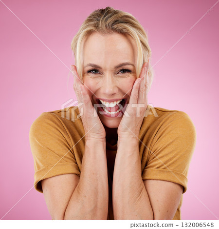 Surprised, wow and portrait of mature woman scream from good news and discount surprise. Isolated, pink background and studio of a person with happiness and excited with hands to face feeling shocked Surprised, wow and portrait of mature woman scream from good news and discount surprise. Isolated, pink background and studio of a person with happiness and excited with hands to face feeling shocked 132006548