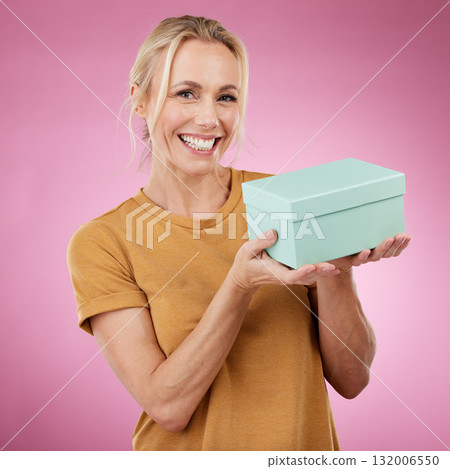 Gift, box and portrait of woman in studio with smile, pink background and package. Happy female model, present and surprise for birthday celebration, excited giveaway and promotion to celebrate deal 132006550
