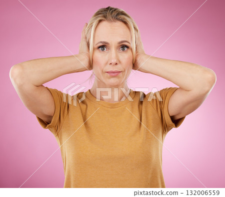 Stress, loud and portrait of a woman with a problem isolated on a pink background in a studio. Sound, frustrated and mature person covering and blocking ears from noise for silence on a backdrop 132006559