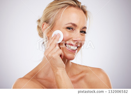 Portrait, cotton and woman in studio for mature, skincare and wrinkle cosmetic treatment on grey background. Face, pad and cleaning by mature lady model for beauty, product or luxury hygiene isolated 132006582
