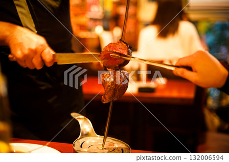 Man grilling churrasco Man grilling churrasco 132006594