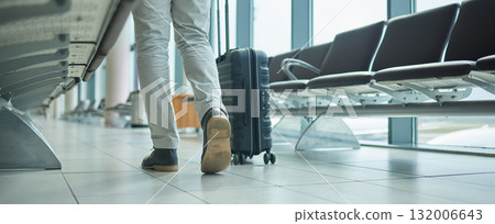 Airport, suitcase and person legs walking to flight for international opportunity or global journey in lobby. Luggage of entrepreneur or business man feet with vacation, travel agency or hospitality Airport, suitcase and person legs walking to flight for international opportunity or global journey in lobby. Luggage of entrepreneur or business man feet with vacation, travel agency or hospitality 132006643