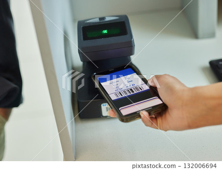 Hands, phone and ticket scan at airport for travel, immigration or transport service by terminal. Hand of traveler scanning smartphone online boarding pass, barcode or permit on mobile flight app 132006694