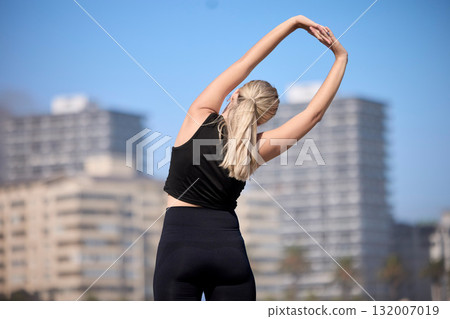 Rear view, woman and stretching arms outdoors for training, running and morning cardio routine. Back, warm up and stretch before fitness, exercise and sports workout, wellness and performance 132007019
