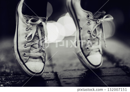 Balance, shoes or fashion in grayscale on an urban street outdoor for dance or contemporary style. Feet, sneakers or footwear in black and white in a city to explore for travel, tourism or adventure Balance, shoes or fashion in grayscale on an urban street outdoor for dance or contemporary style. Feet, sneakers or footwear in black and white in a city to explore for travel, tourism or adventure 132007151