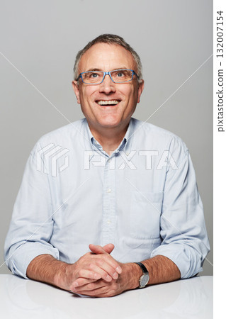 Happy, smile and mature man in a studio with a good, confident and positive mindset with glasses. Happiness, spectacles and senior male person with excited face expression isolated by gray background Happy, smile and mature man in a studio with a good, confident and positive mindset with glasses. Happiness, spectacles and senior male person with excited face expression isolated by gray background 132007154