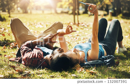 Love, selfie and couple in park, grass and bonding with romance, dating and relationship. Romantic, man and woman with smartphone, peace sign and loving together, happiness and outdoor for fun or joy Love, selfie and couple in park, grass and bonding with romance, dating and relationship. Romantic, man and woman with smartphone, peace sign and loving together, happiness and outdoor for fun or joy 132007391