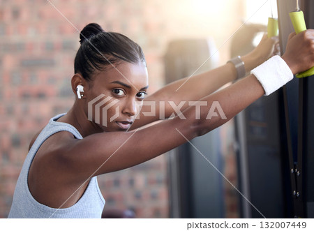 Fitness, exercise and portrait of a woman with music at gym for health and wellness with training workout. Indian athlete person listening to earphones for motivation and inspiration to train body 132007449