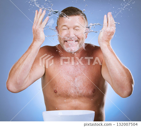 Skincare, senior man and water splash with basin, dermatology and guy with blue studio background. Face detox, mature male and old gentleman with clear liquid, hygiene or aqua for freshness with bowl 132007504