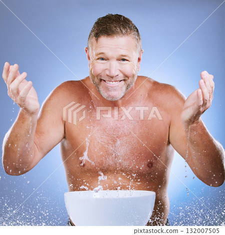 Skincare, water and man washing face in a studio for a beauty, natural and cosmetic routine. Happy, smile and portrait of a senior male model doing a facial cleansing treatment by a purple background 132007505