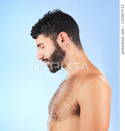 Man, shower and profile of a model in water for cleaning, skincare and hygiene wellness. Isolated, blue background and studio with a young person in bathroom for dermatology and self care routine Man, shower and profile of a model in water for cleaning, skincare and hygiene wellness. Isolated, blue background and studio with a young person in bathroom for dermatology and self care routine 132007512