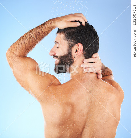 Hair, washing and man in studio for skincare, grooming and hygiene against blue background. Haircare, body care and guy model relax in shower, happy and isolated on water splash, cosmetic or wellness Hair, washing and man in studio for skincare, grooming and hygiene against blue background. Haircare, body care and guy model relax in shower, happy and isolated on water splash, cosmetic or wellness 132007513