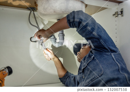 Plumber, man and maintenance with plumbing, home renovation and manual labour with tools. Construction, DIY skills and professional, fixing pipe in industry and male with trade, repairs and handyman Plumber, man and maintenance with plumbing, home renovation and manual labour with tools. Construction, DIY skills and professional, fixing pipe in industry and male with trade, repairs and handyman 132007538