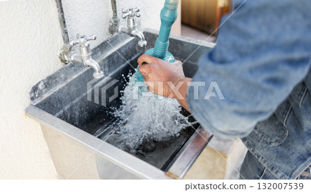 Plumber, water and man with plunger for kitchen sink, maintenance and repairs, blockage or cleaning. Plumbing, drain and professional handyman fixing, clear and working with equipment for system fix 132007539