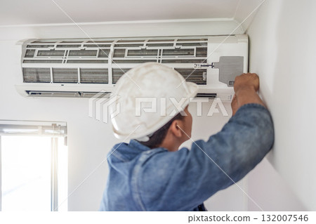 Air conditioner, ac repair and building hvac maintenance of a handyman and builder on home renovation. Electric technician, service worker and contractor in a house for equipment installation on wall 132007546
